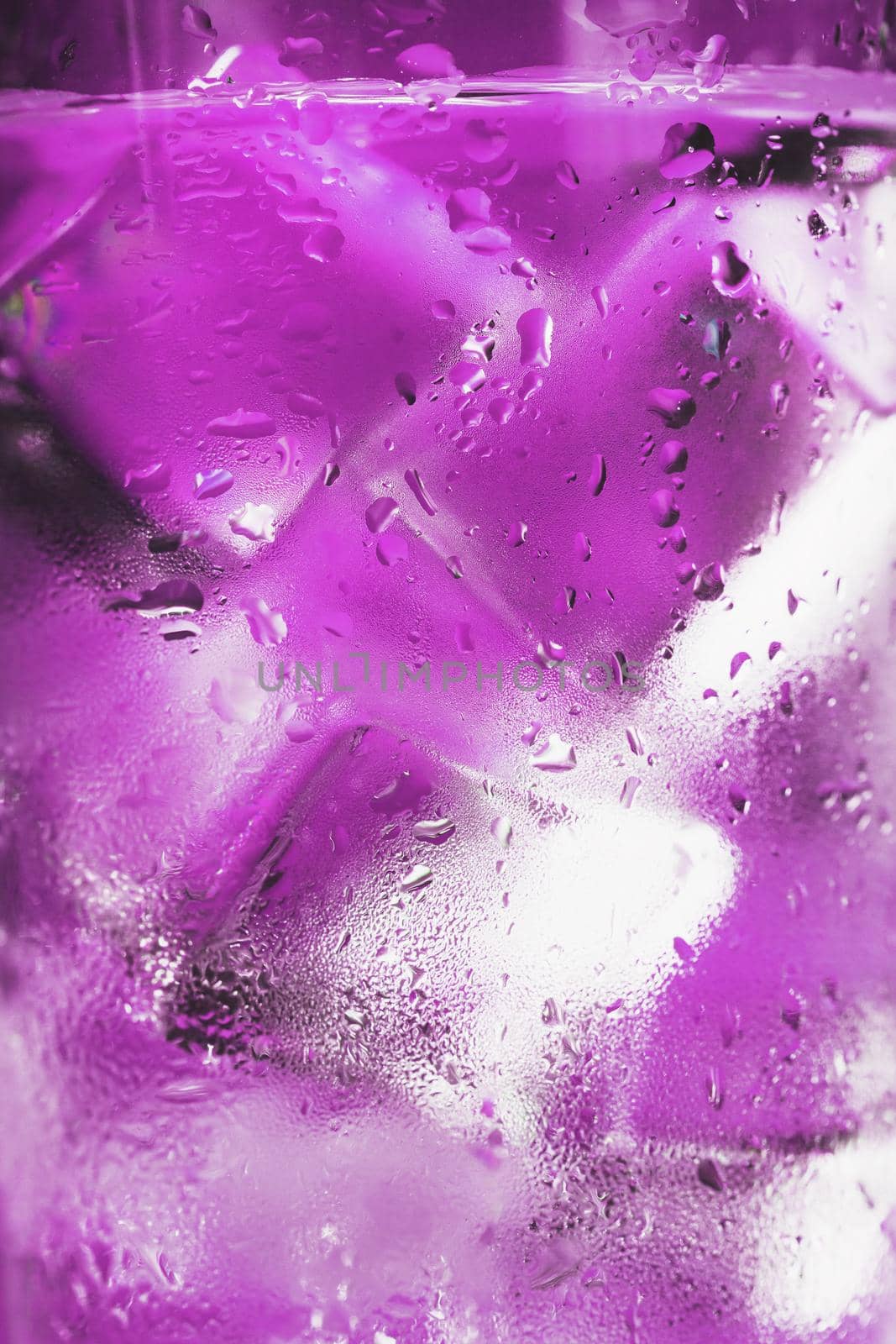 Ice cubes in a misted glass with drops of ice water close-up macro. Soft Selective Focus by AlexGrec