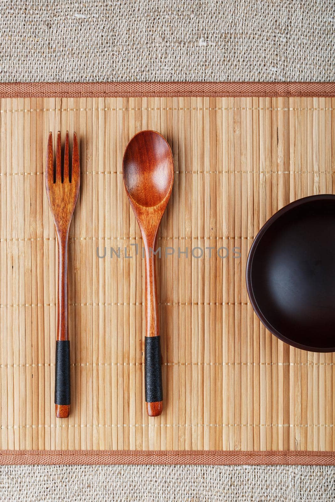 Natural wood plate, spoon and fork on a bamboo backing. by AlexGrec
