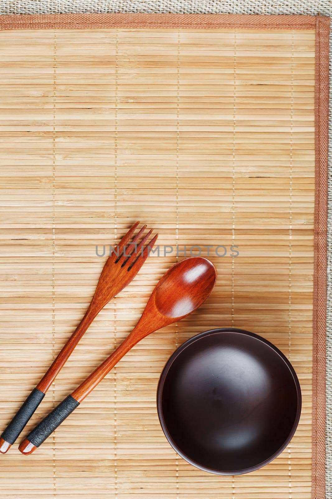 Natural wood plate, spoon and fork on a bamboo backing. by AlexGrec