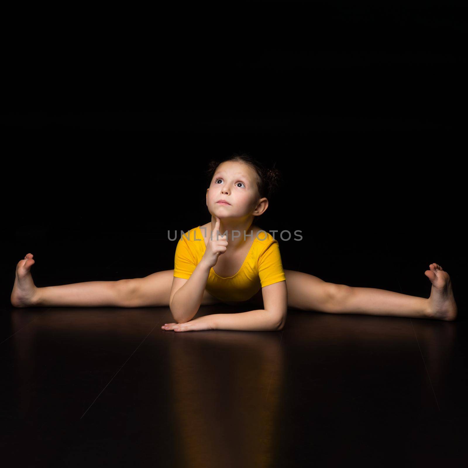 Cute young girl sitting on cross transverse splits by kolesnikov_studio