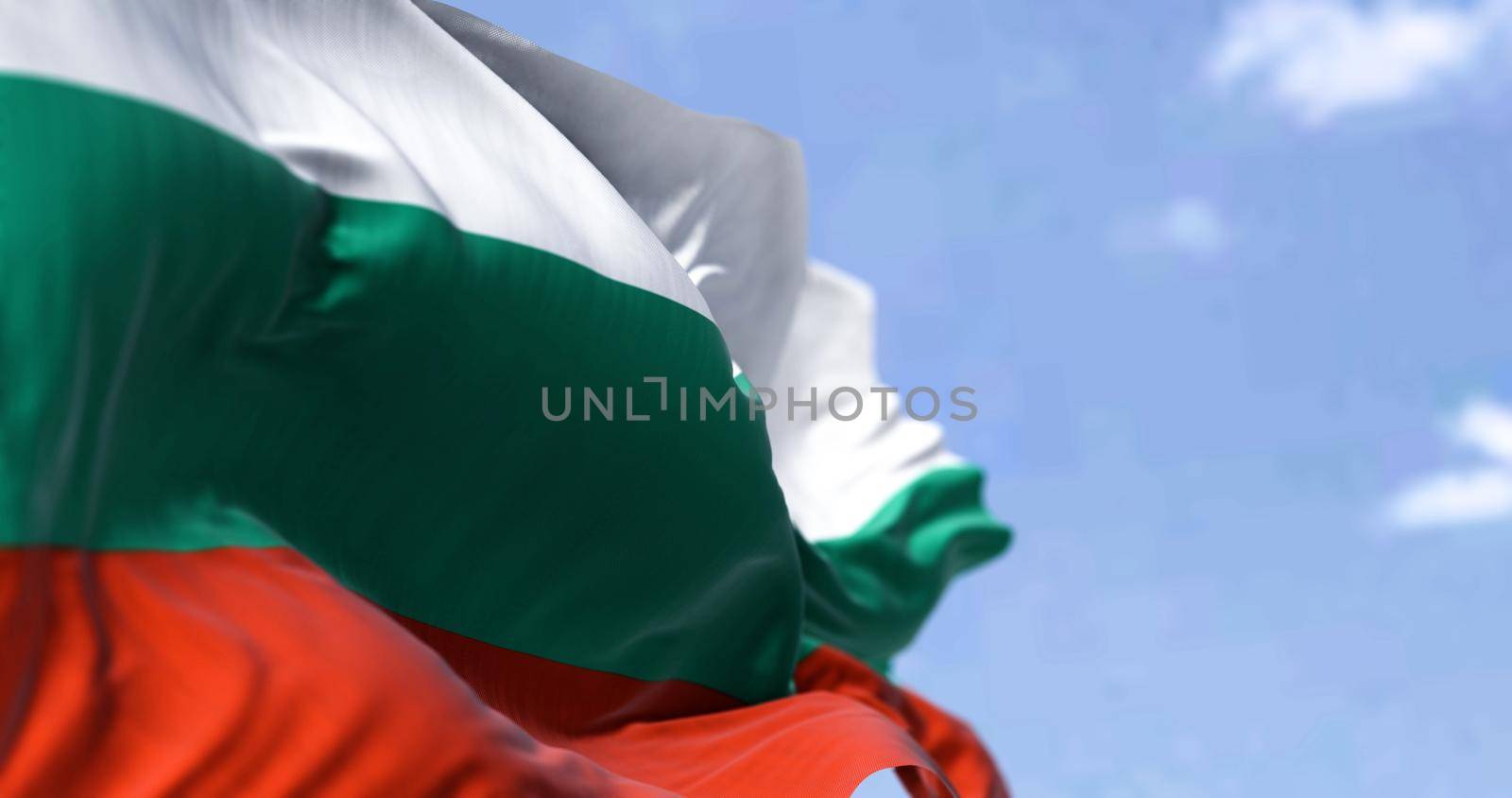 Detail of the national flag of Bulgaria waving in the wind on a clear day by rarrarorro