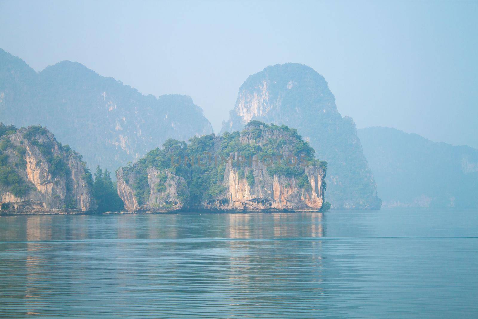 island and rocks in thailand near the blue sea in fog by dreamloud