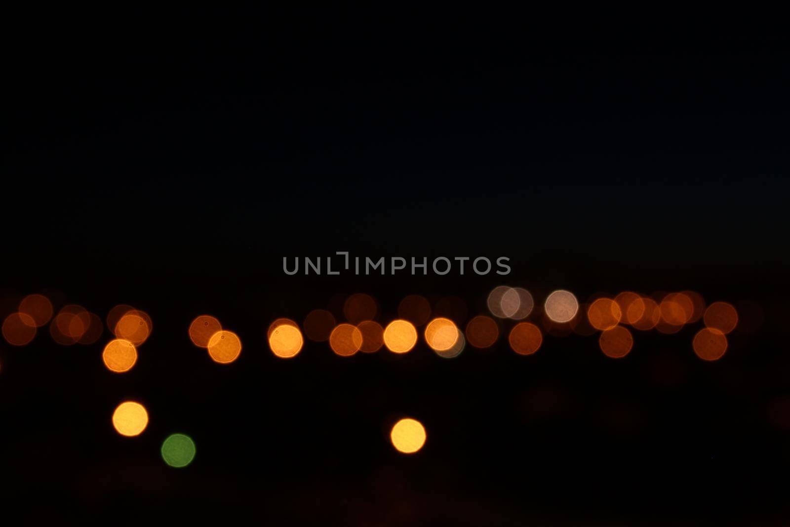 Night lights bokeh background. City flashlights defocused