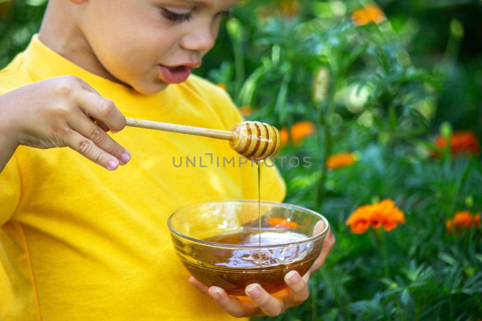 child eats honey in the garden. Nature. selective focus