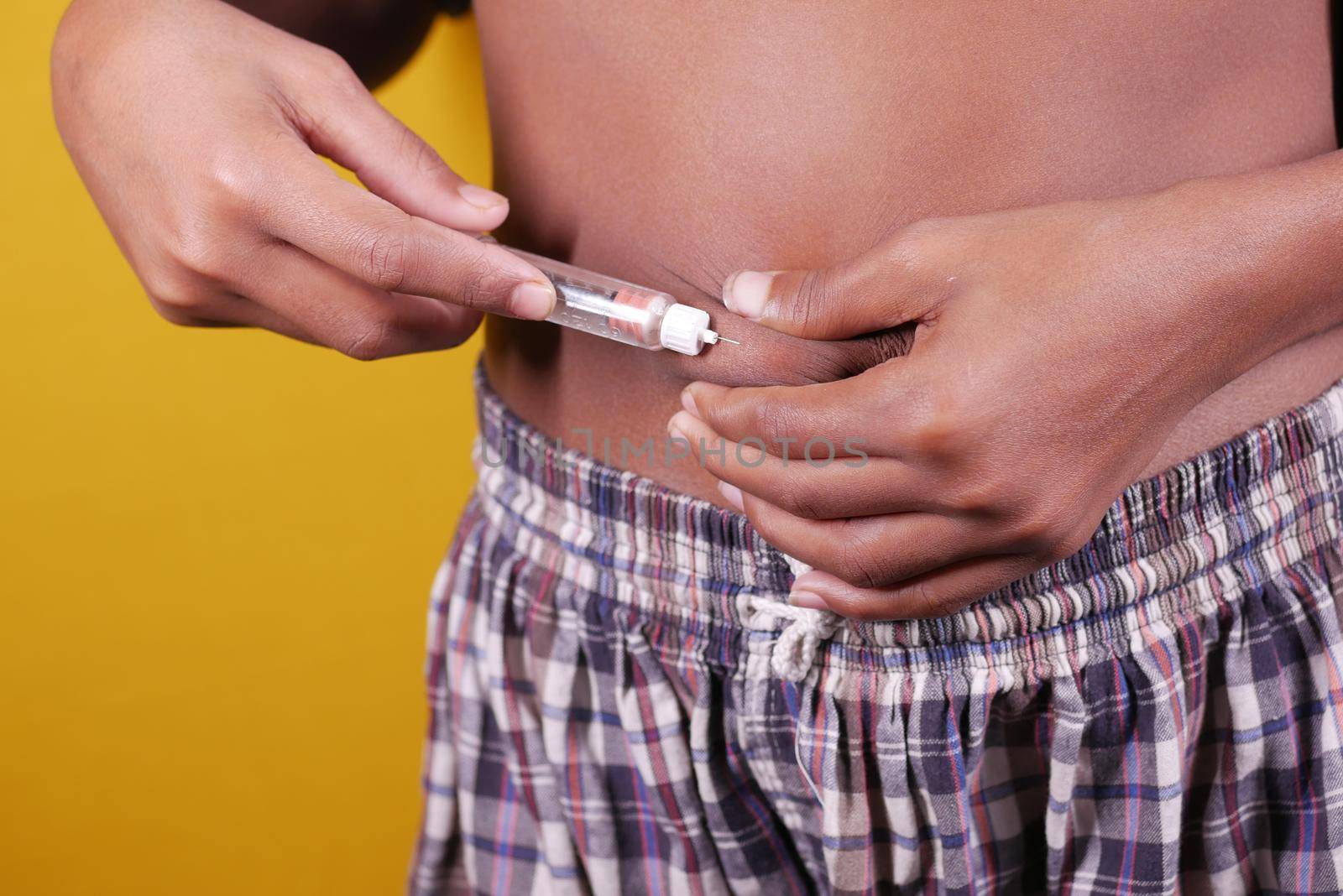 young man hand using insulin pen close up .