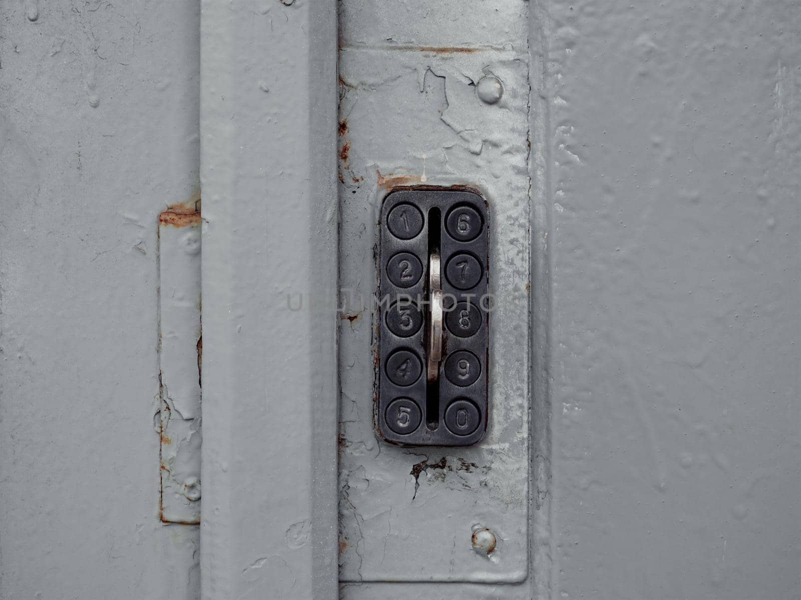 Secure password on keyboard for opening house door. Old system of protect and safe in the past. Vintage combination lock with buttons on the grey wooden grunge door to unlock.