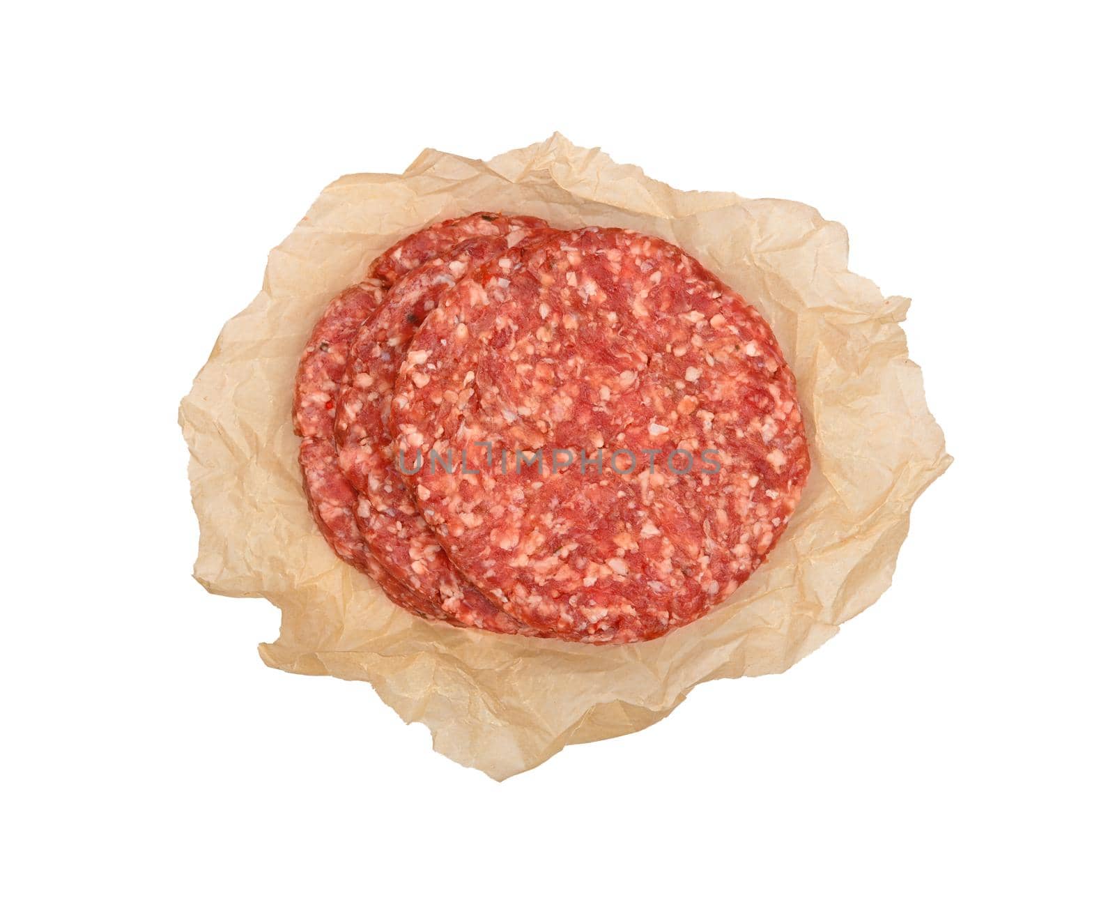 Raw beef meat hamburgers on brown paper by BreakingTheWalls