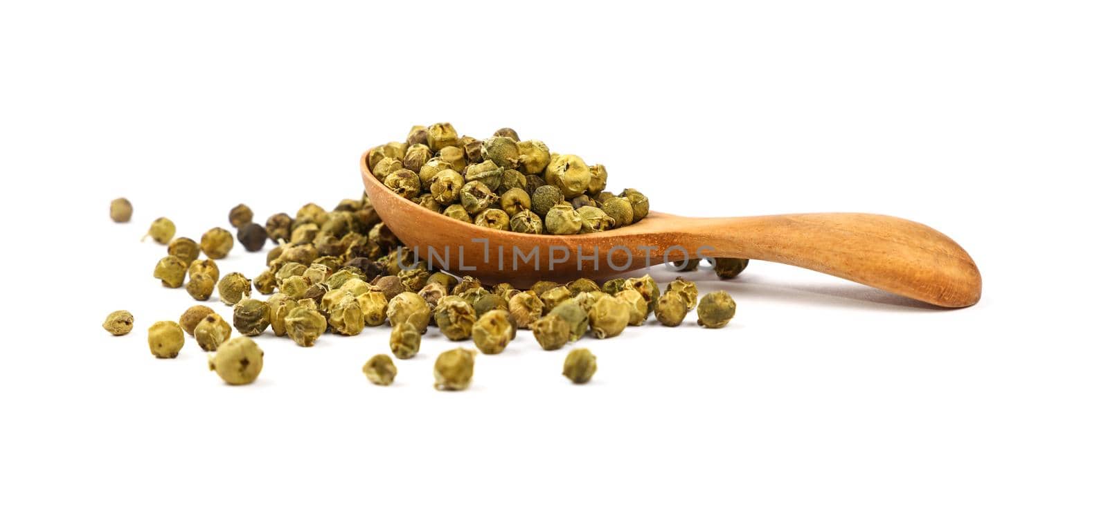Close up one wooden scoop spoon full of green pepper peppercorns and heap of peppercorns spilled and spread around isolated on white background, low angle, side view