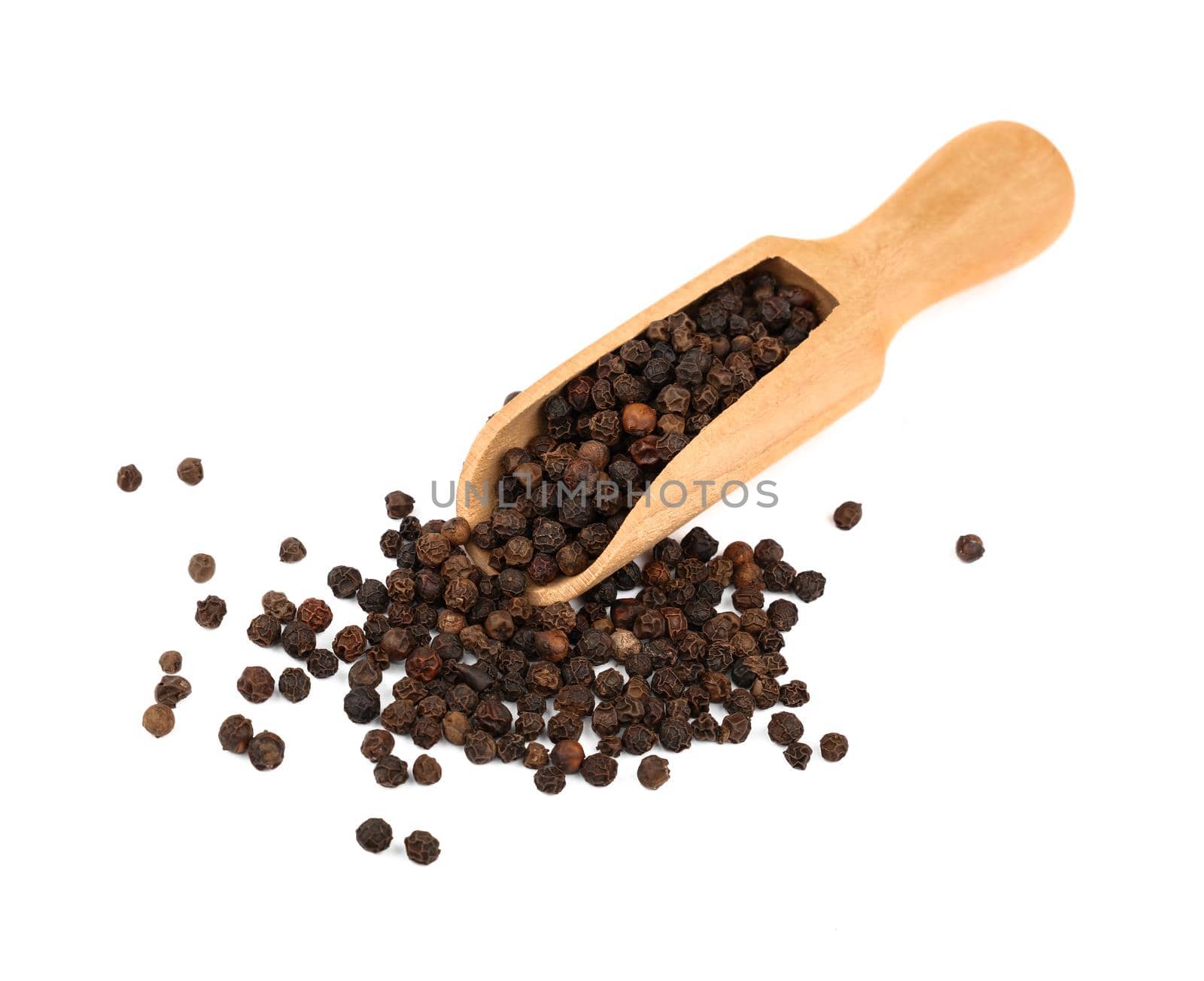 Close up one wooden scoop full of black pepper peppercorns and heap of peppercorns spilled and spread around isolated on white background, high angle view