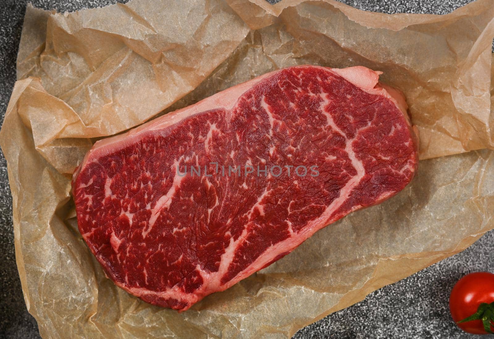 Close up raw beef sirloin steak on paper by BreakingTheWalls
