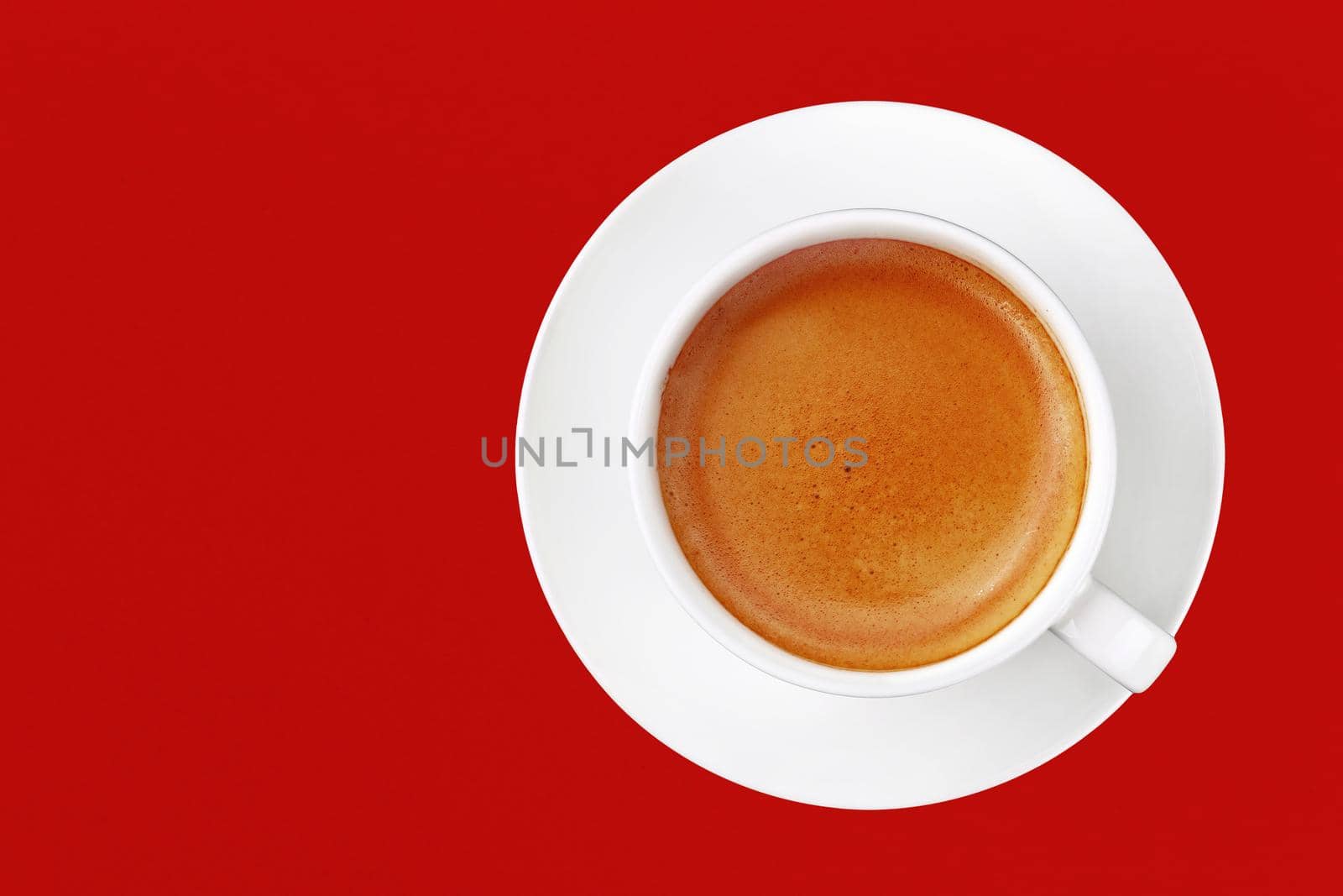 Full cup of espresso coffee on red by BreakingTheWalls