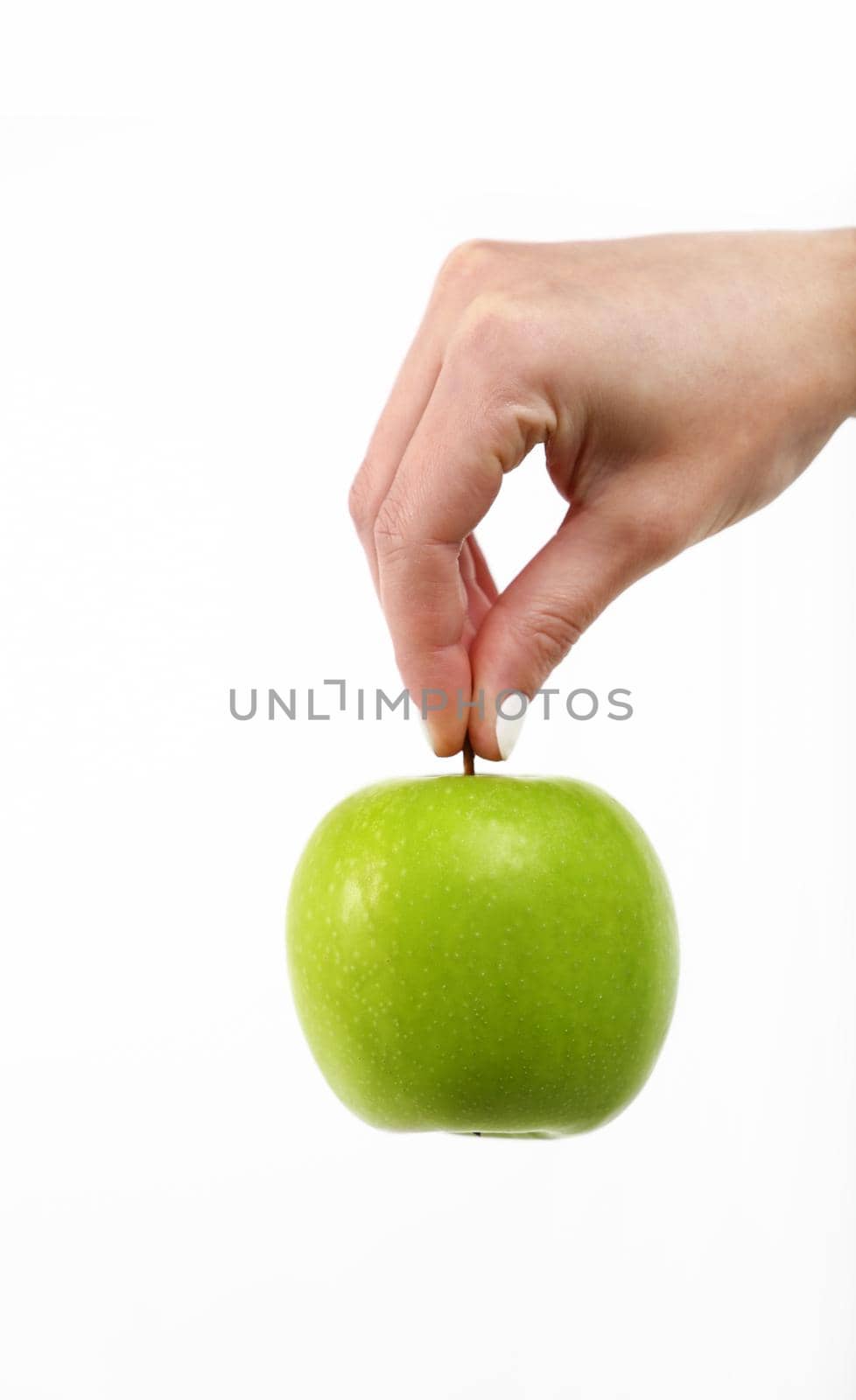 Woman hand holds green apple over white by BreakingTheWalls