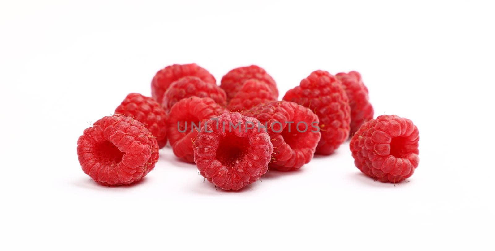Fresh red ripe raspberries isolated on white by BreakingTheWalls