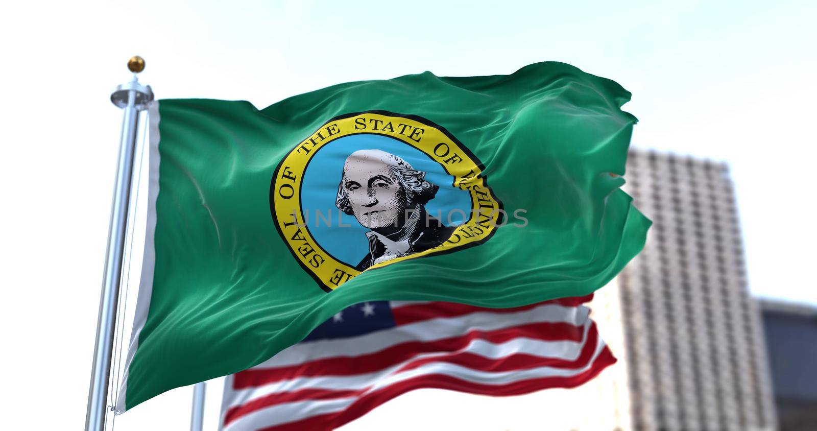 the flag of the US state of Washington waving in the wind with the American flag blurred in the background by rarrarorro