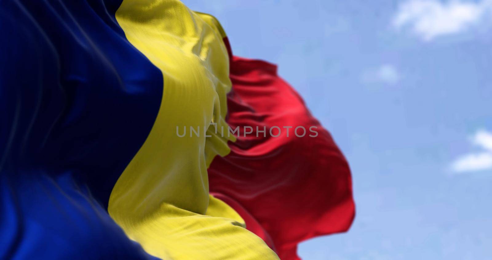 Detail of the national flag of Romania waving in the wind on a clear day by rarrarorro