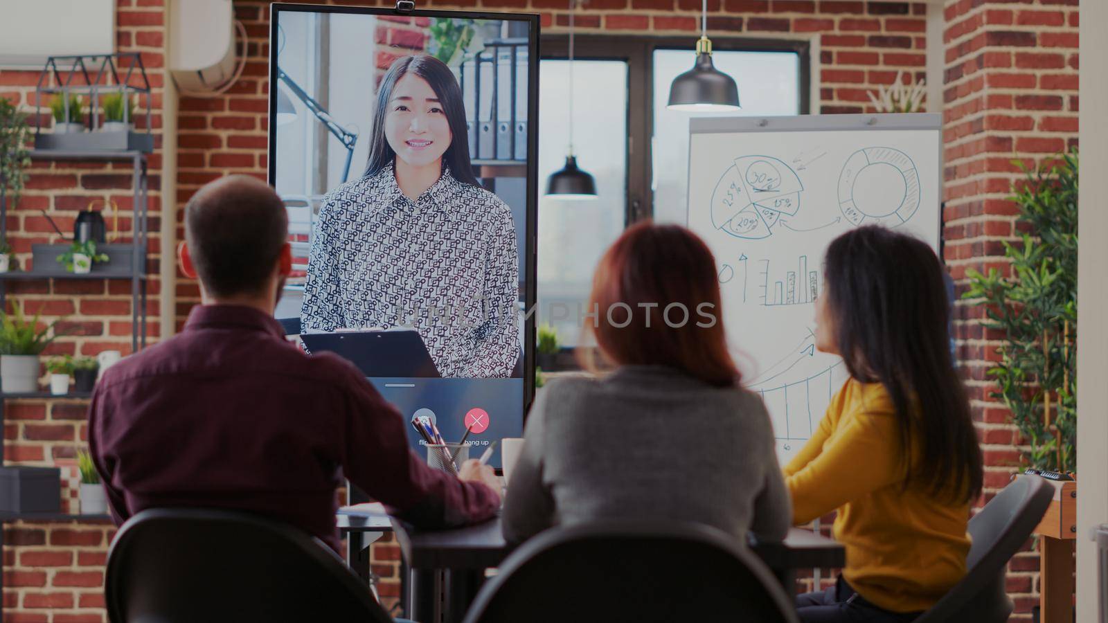 Group of coworkers using video call communication in boardroom by DCStudio
