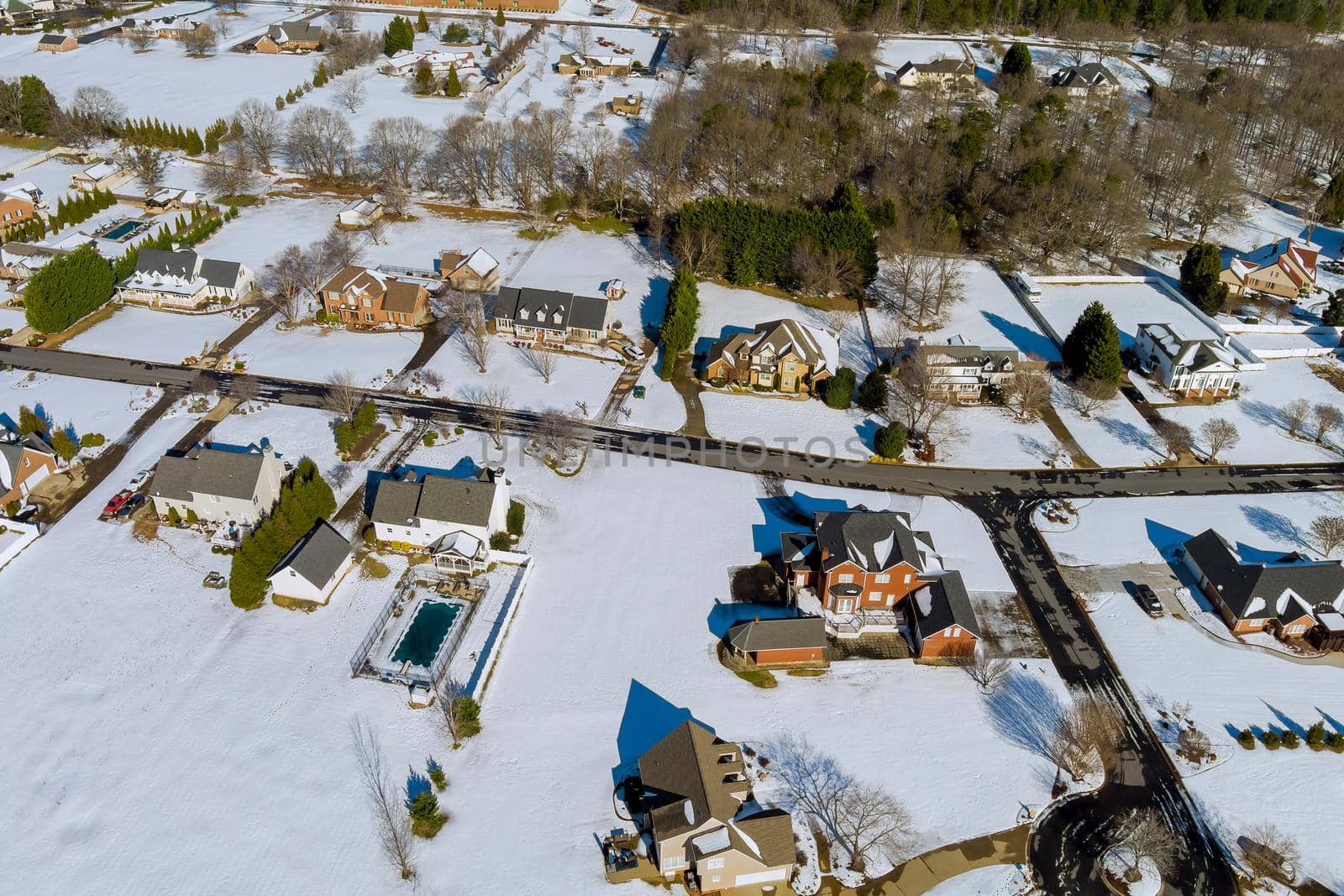 High altitude view of city town residential with snow covered roofs houses neighborhood