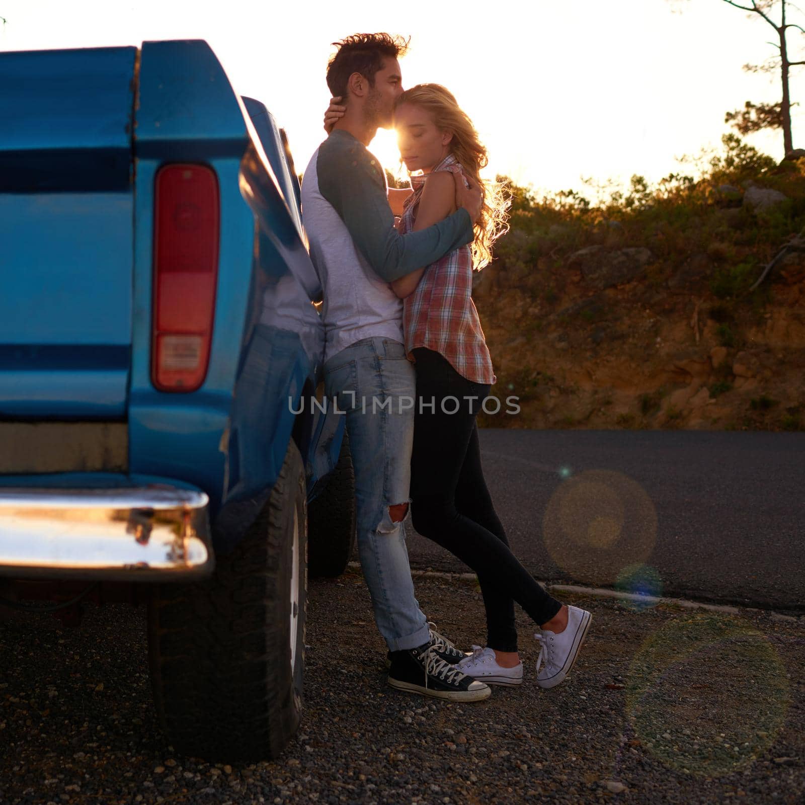 Off road romance. Shot of an affectionate young couple on a roadtrip. by YuriArcurs