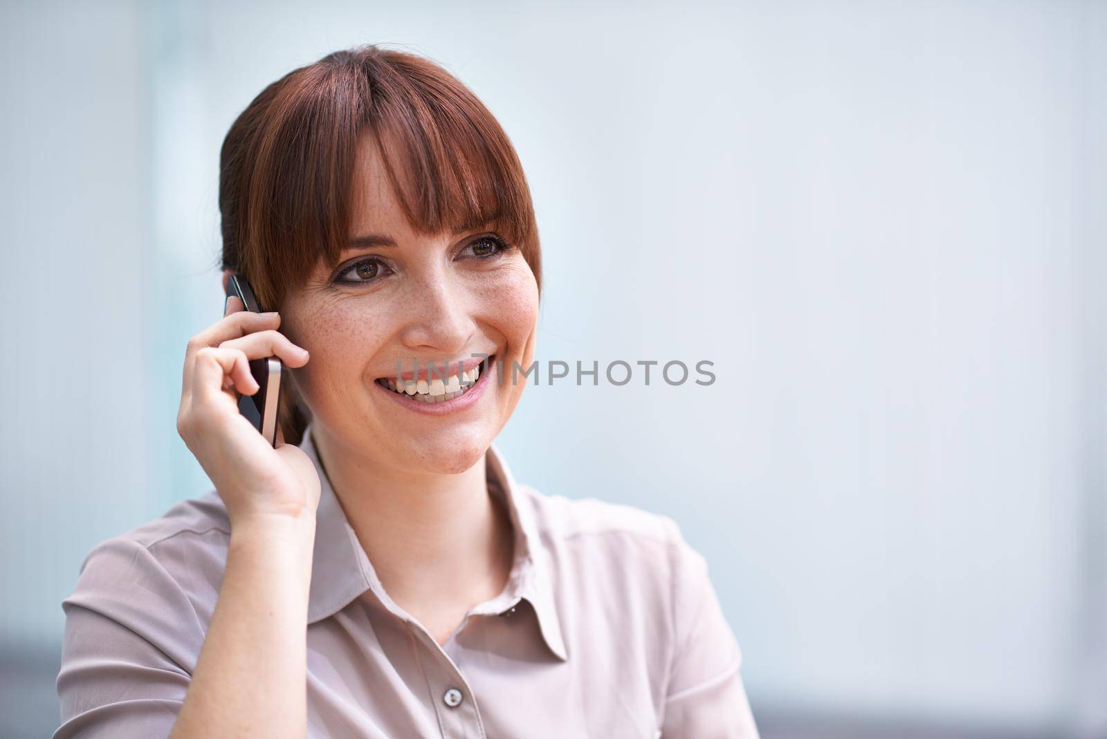 Shot of a beautiful young businesswoman talking on a cellphone
