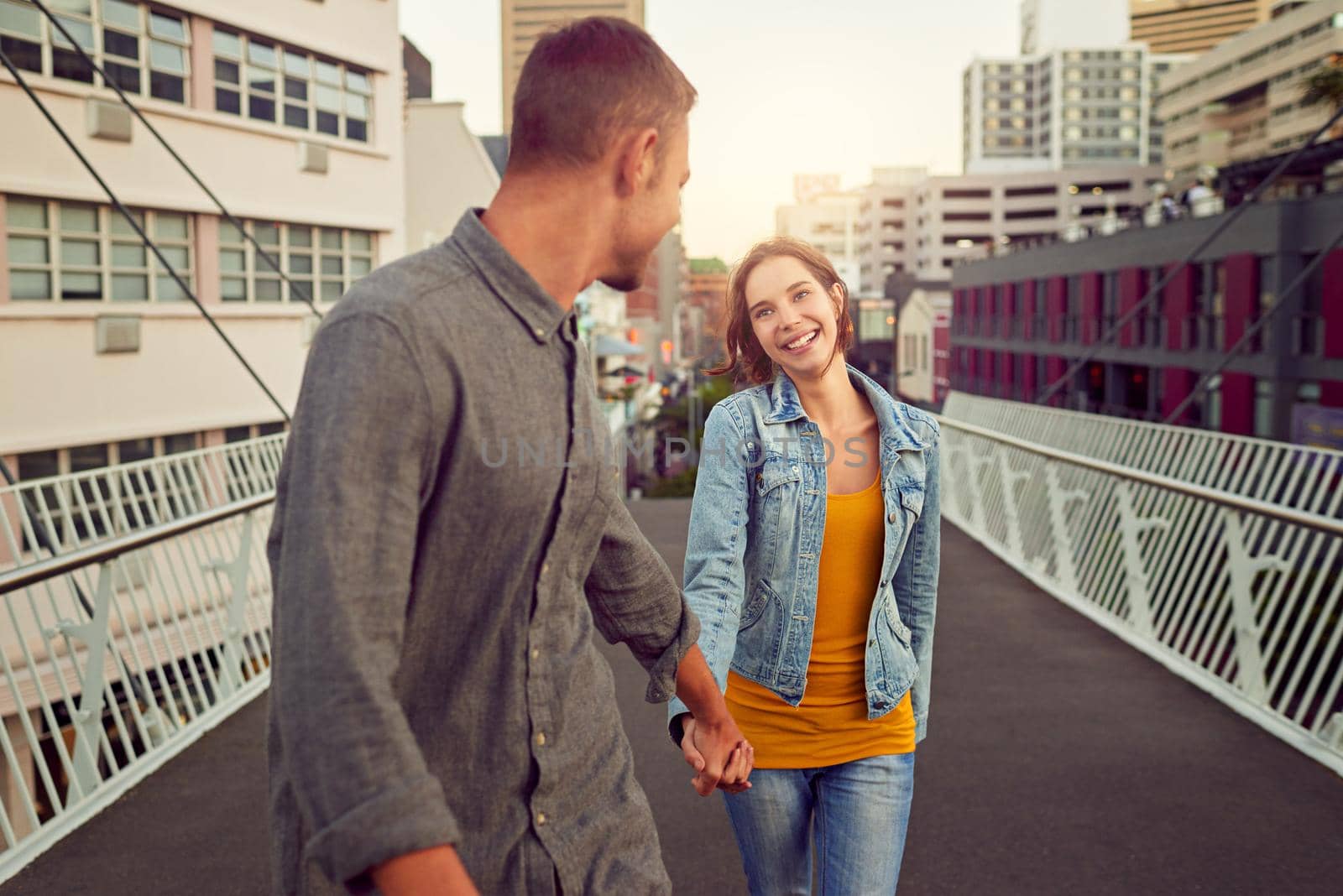 Shot of a happy young couple enjoying a romantic walk together in the city