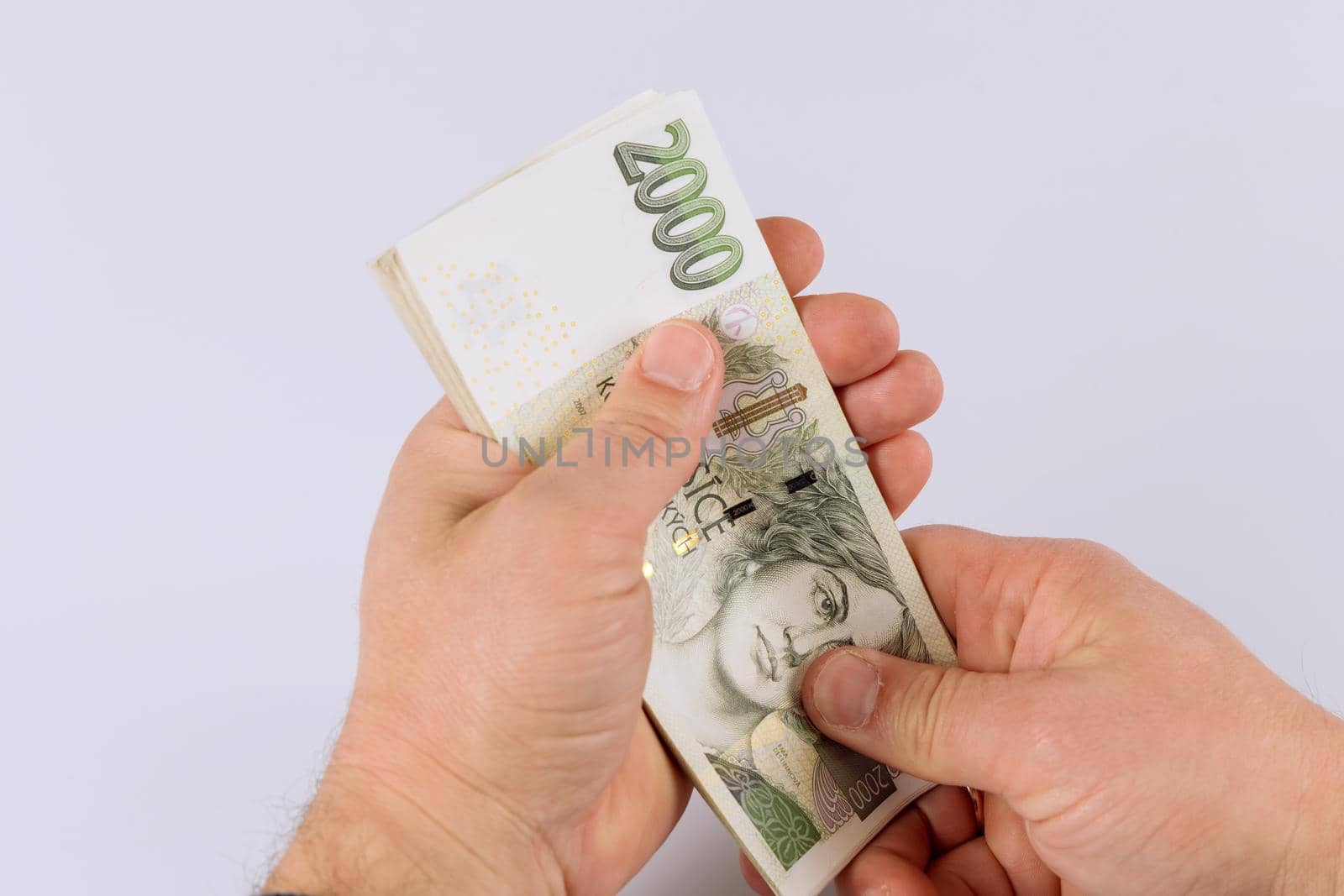 Detail of man hands counting czech koruna money