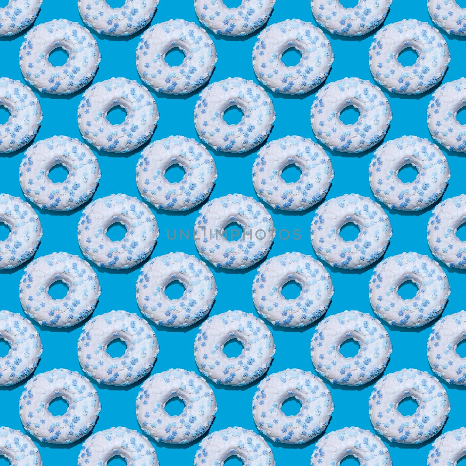seamless donut pattern with a shadow on a blue background. High quality photo