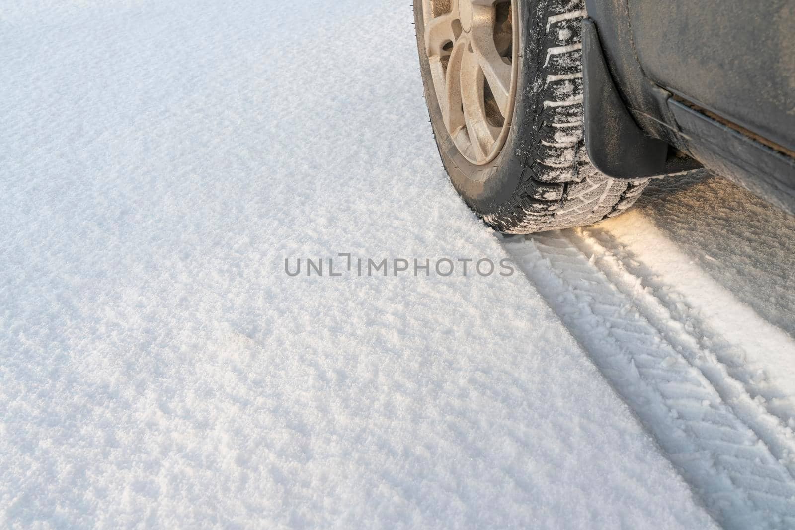 the track of a car wheel in the snow by roman112007