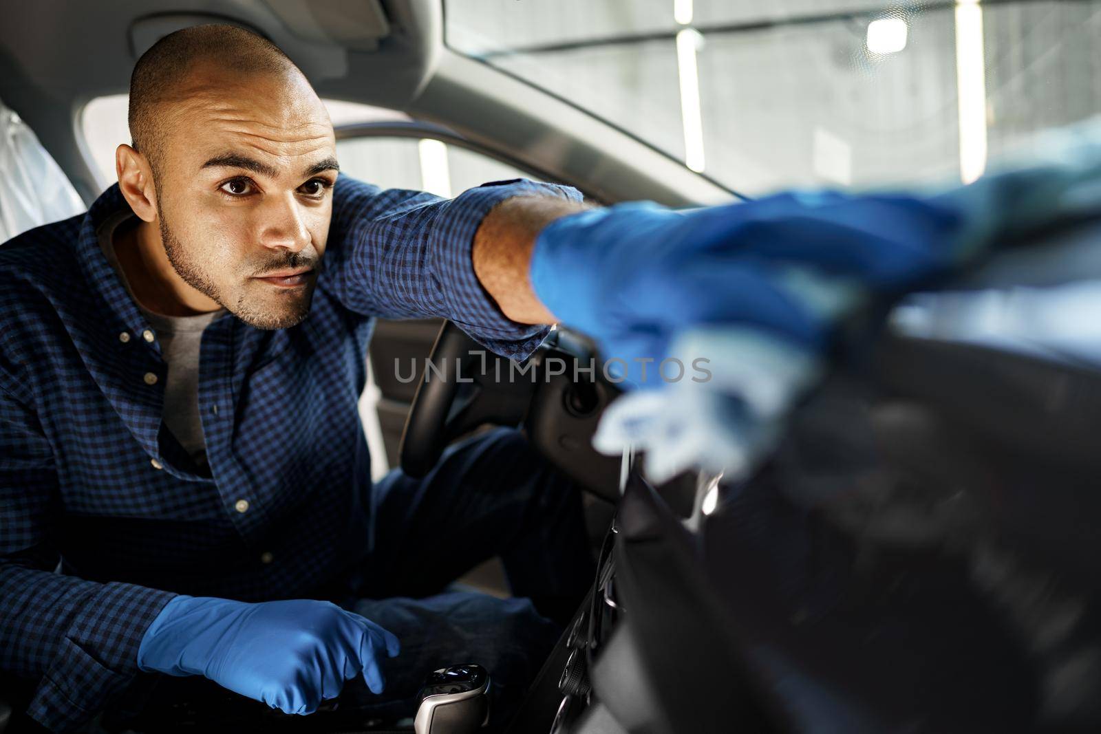 A man cleaning car interior, car detailing in Carwash service, close up