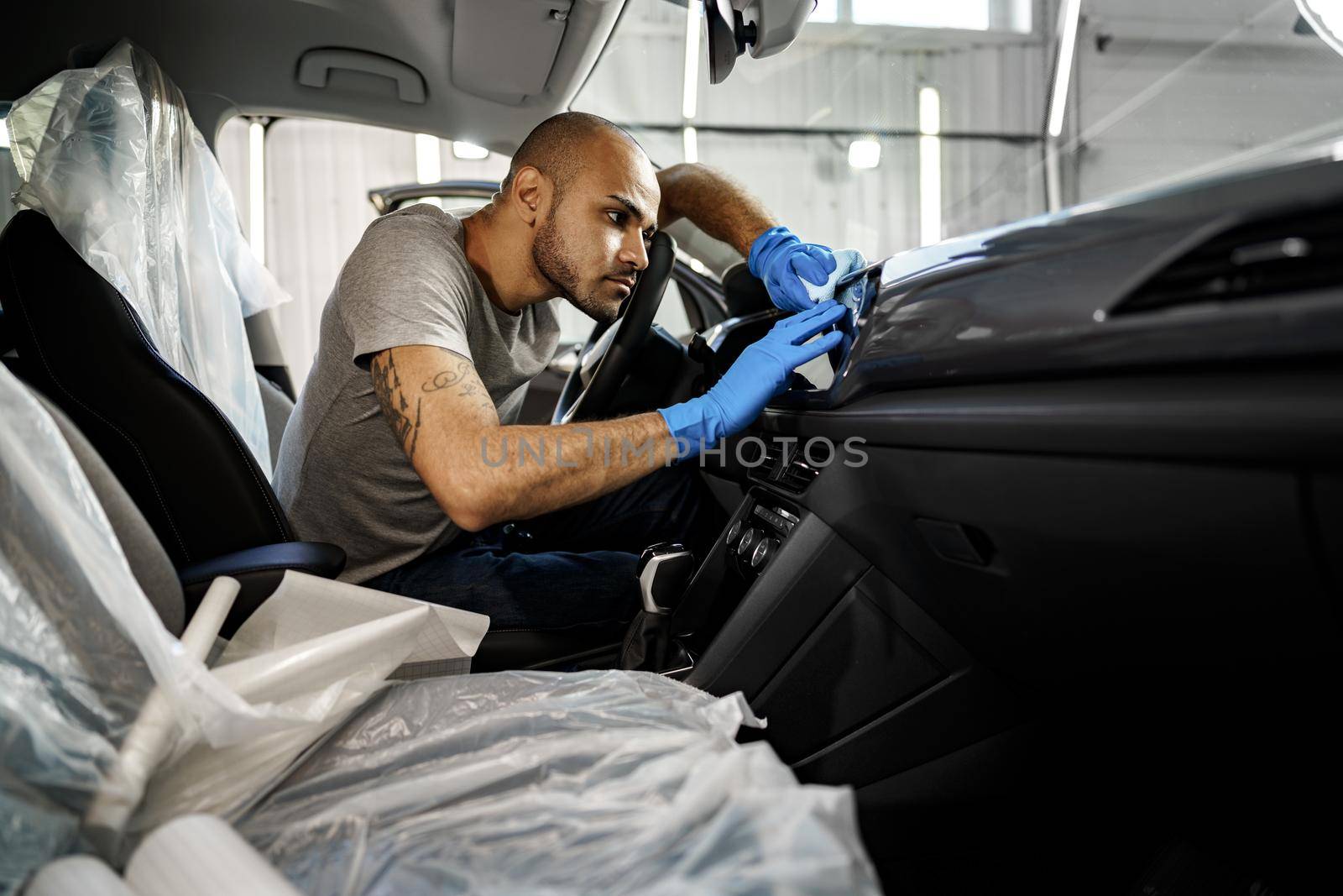 A man cleaning car interior, car detailing in Carwash service, close up