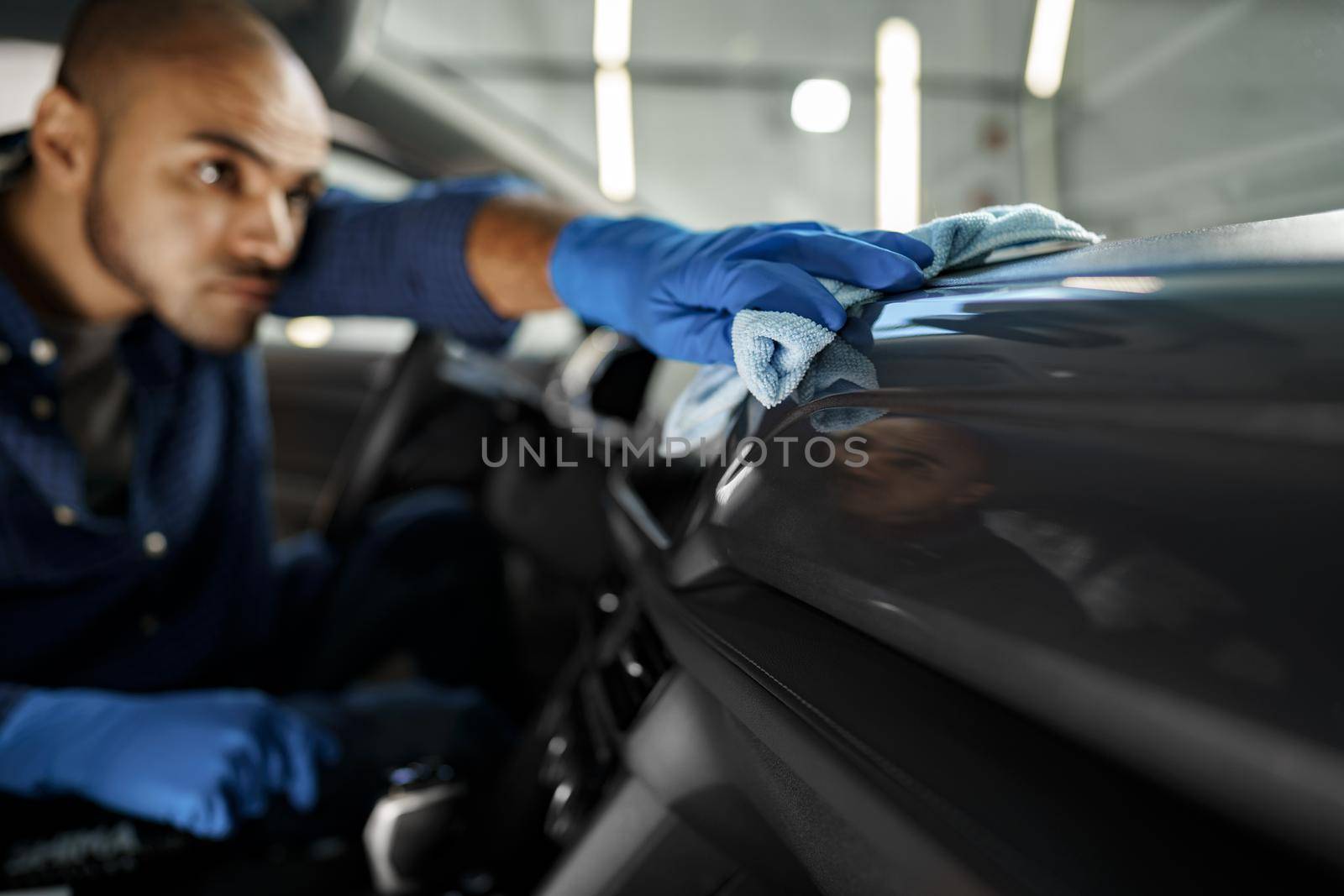 A man cleaning car interior, car detailing in Carwash service, close up