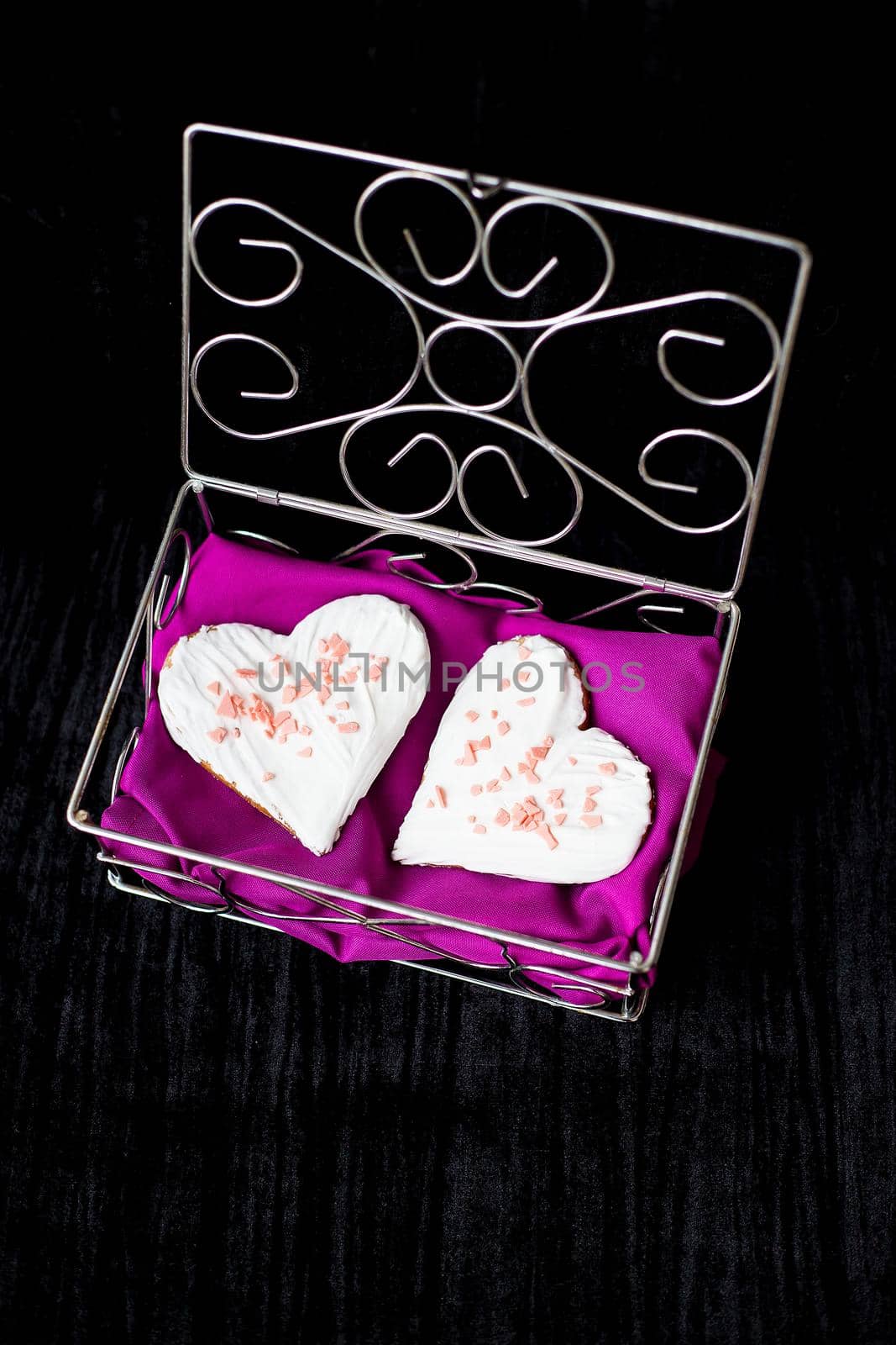 Cookies in the form of heart lies in a casket with pink cloth by sfinks