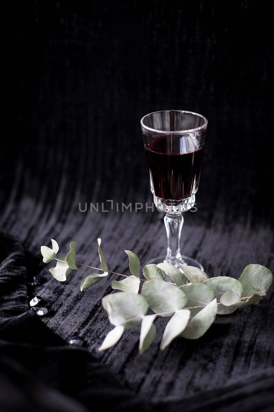twig and glass of red wine on a black background Velvet by sfinks