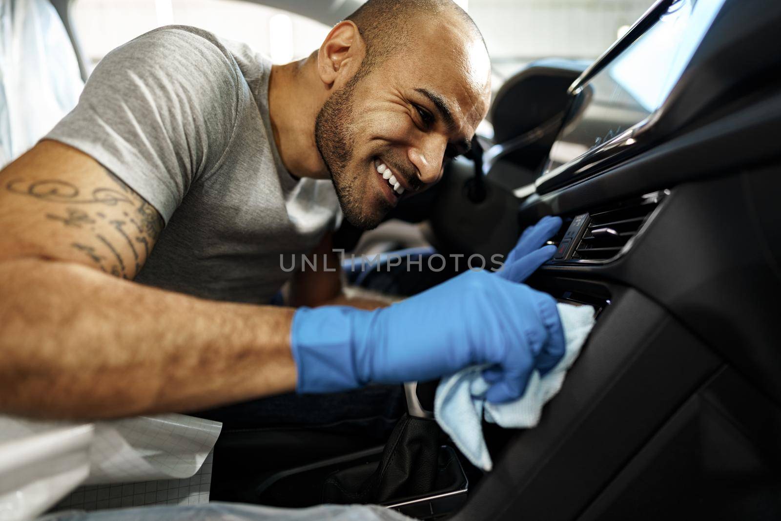 A man cleaning car interior, car detailing in Carwash service, close up