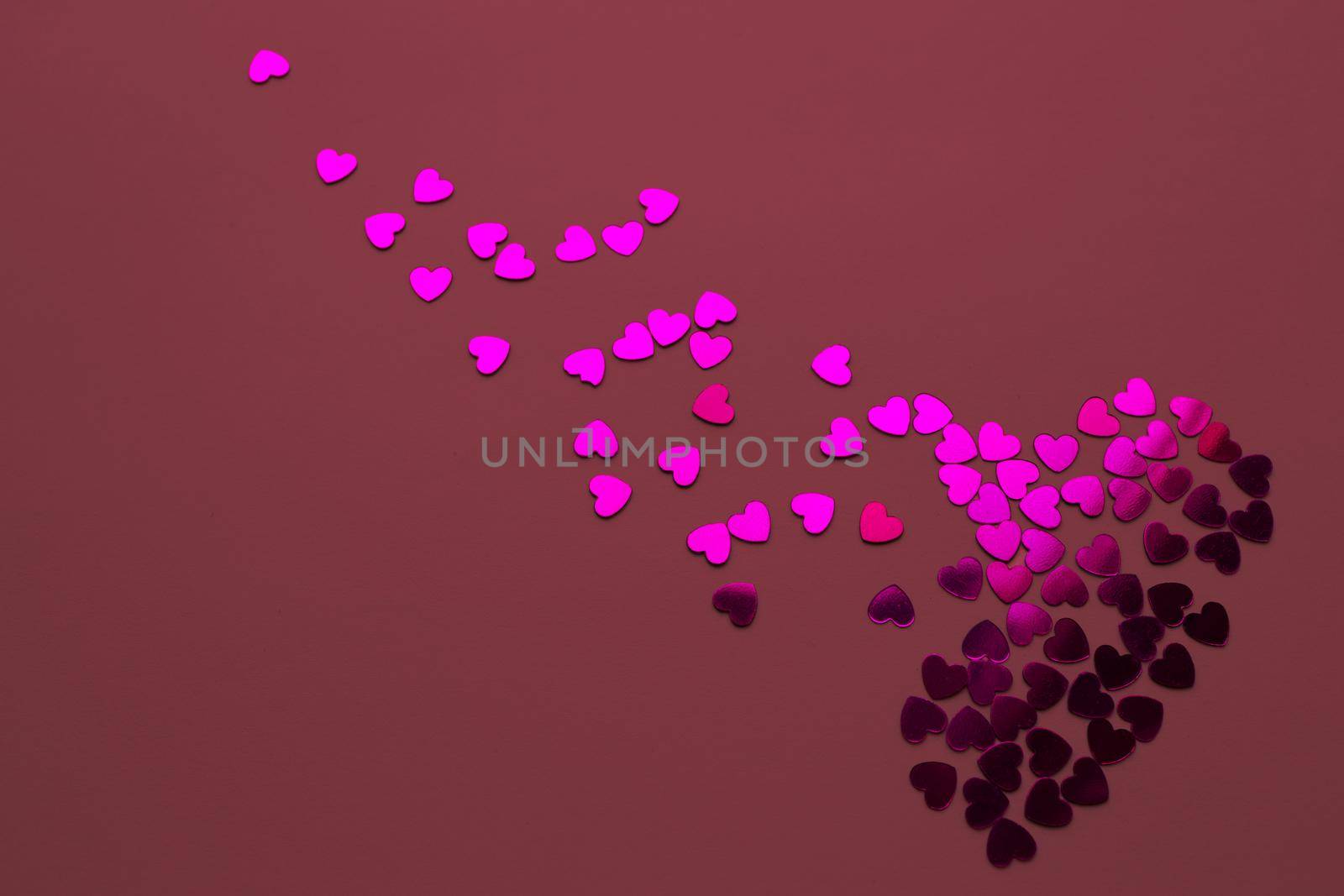Heartbreak concept. Abstract broken heart made from confetti on a red background. Or love romantic couple, Valentine's Day concept. by Proxima13