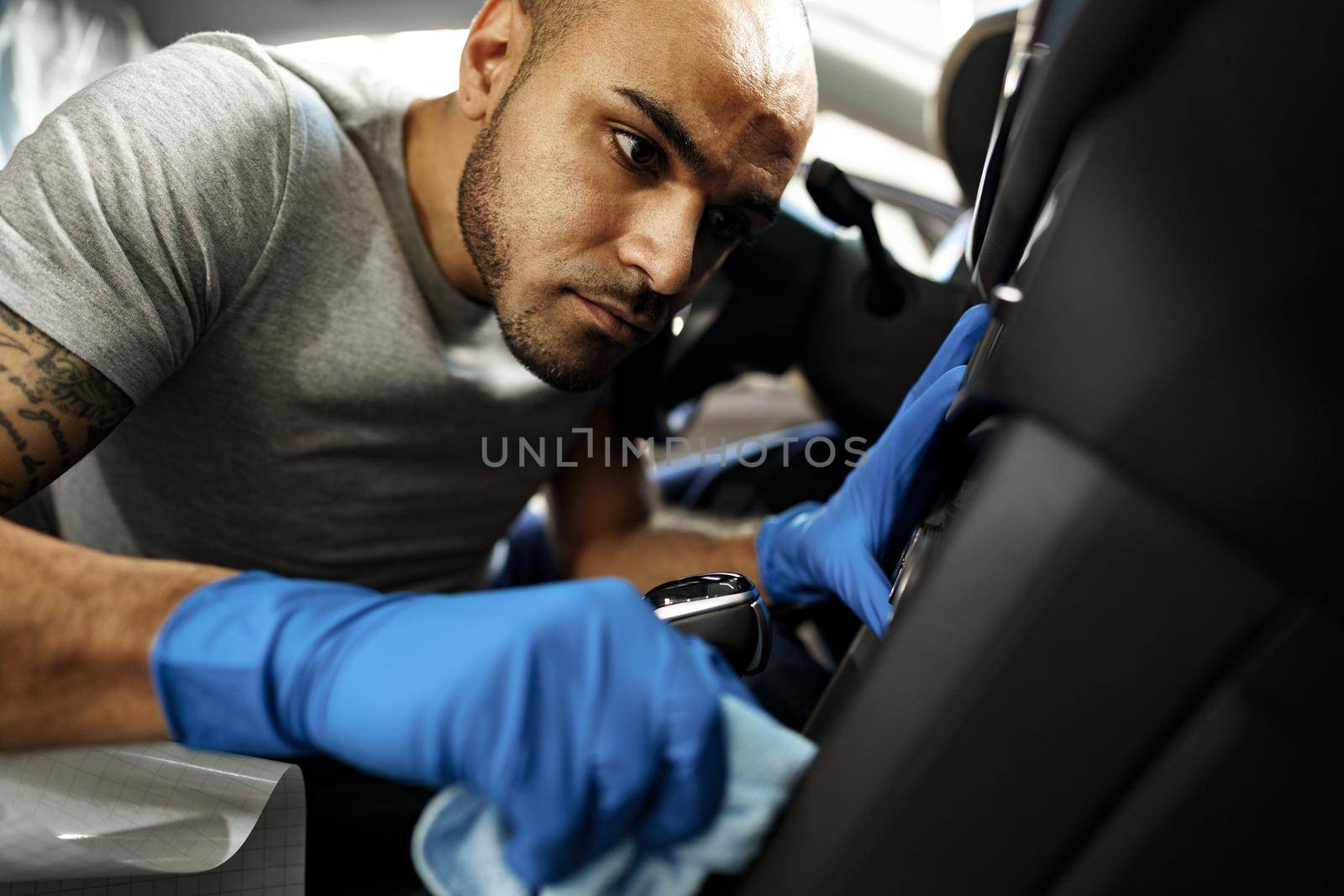 A man cleaning car interior, car detailing in Carwash service, close up
