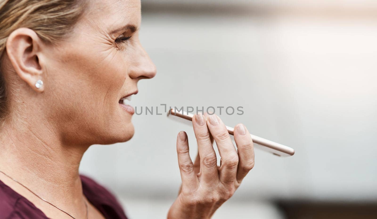 Shot of a mature businesswoman using a smartphone against an urban background