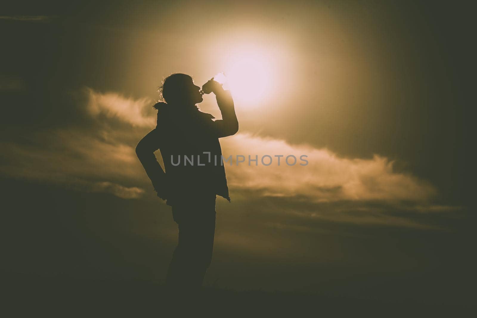 Men drinking water on the hill at dusk. Shooting Location: Tokyo metropolitan area