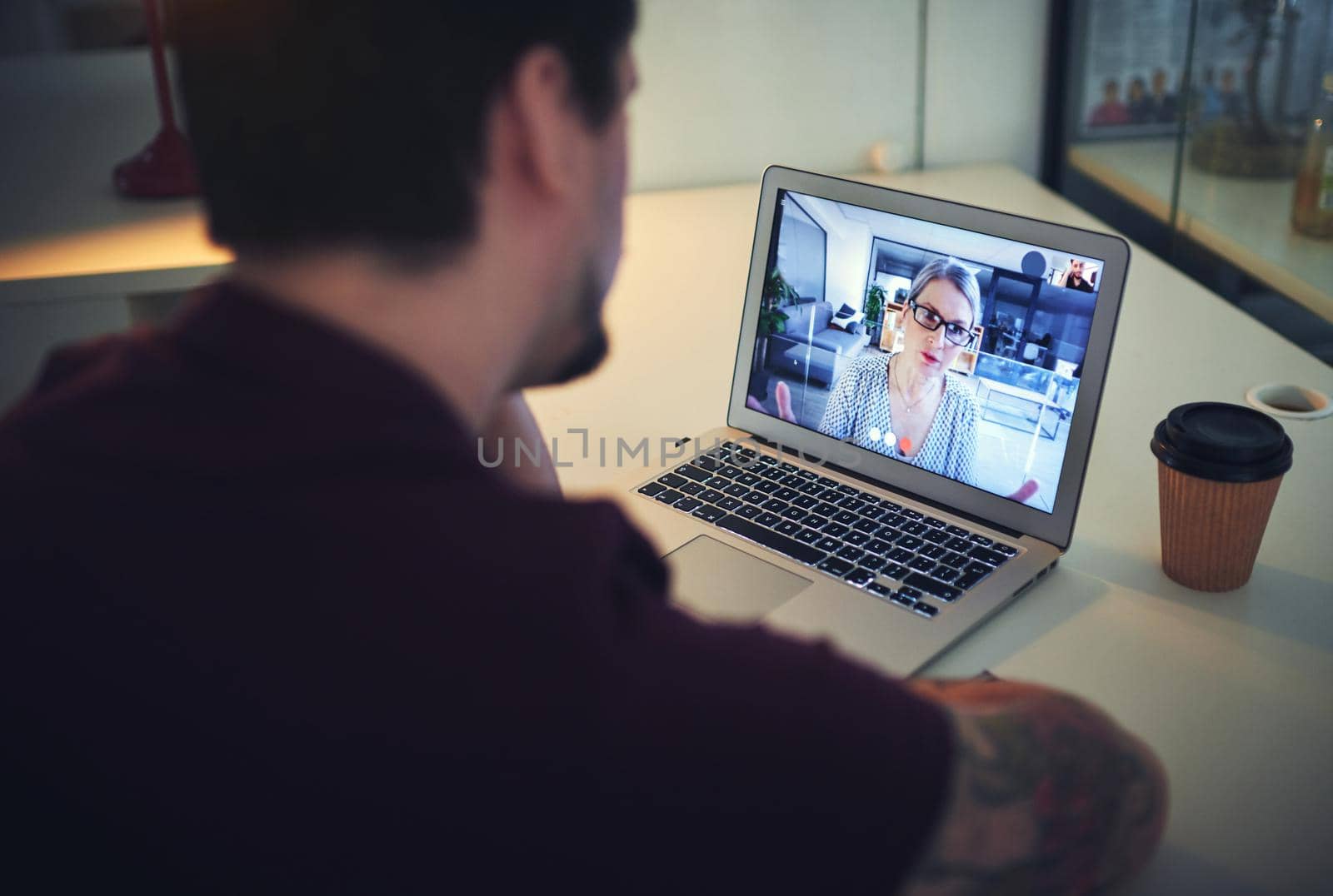 Shot of a mature psychologist conducting an online therapy session with her patient