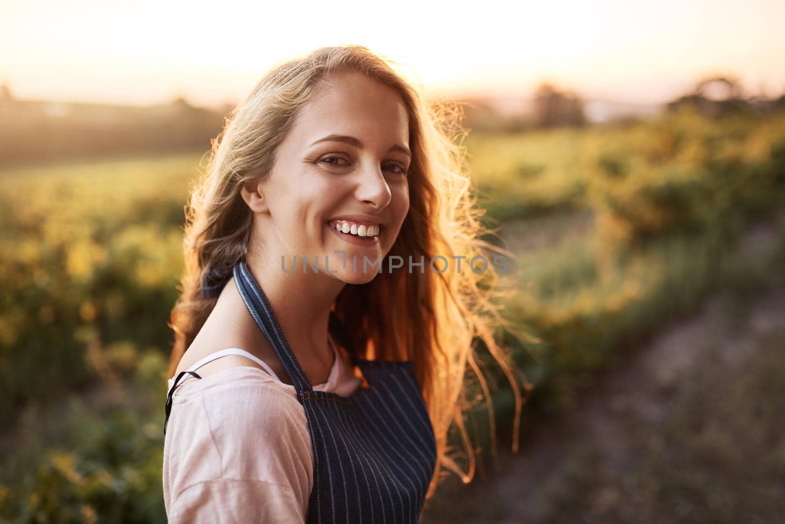 Portrait of a happy young woman working on a farm