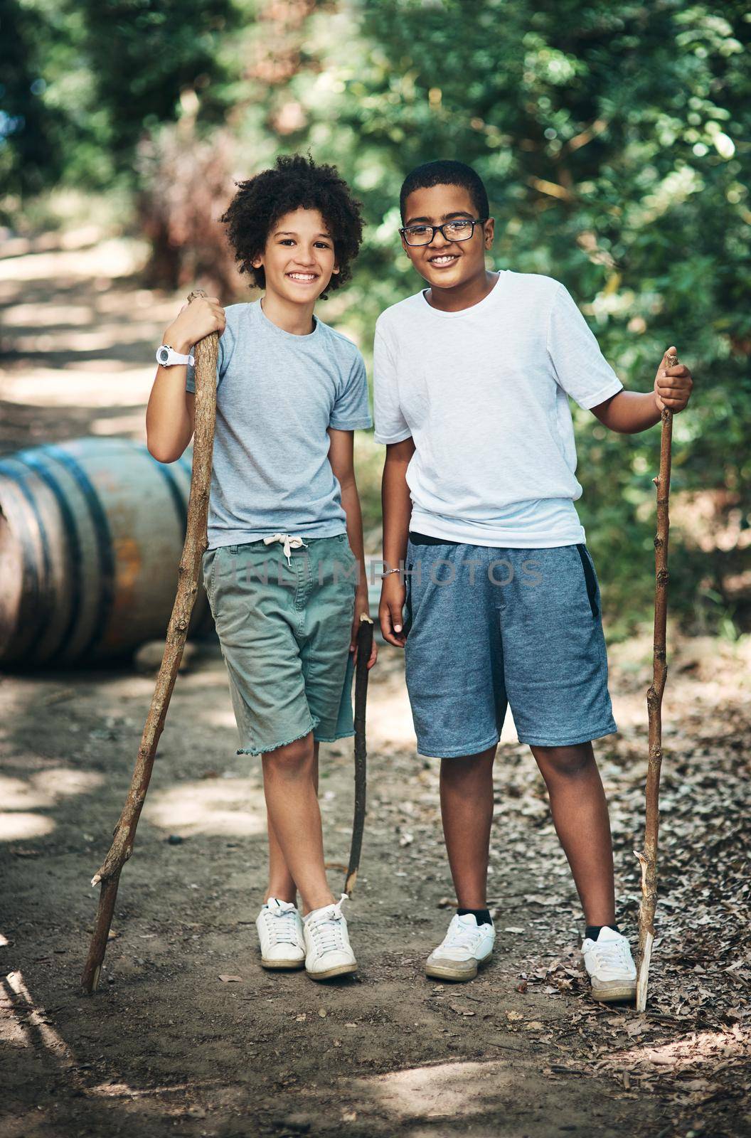 Shot of two teenage boys exploring nature at summer camp