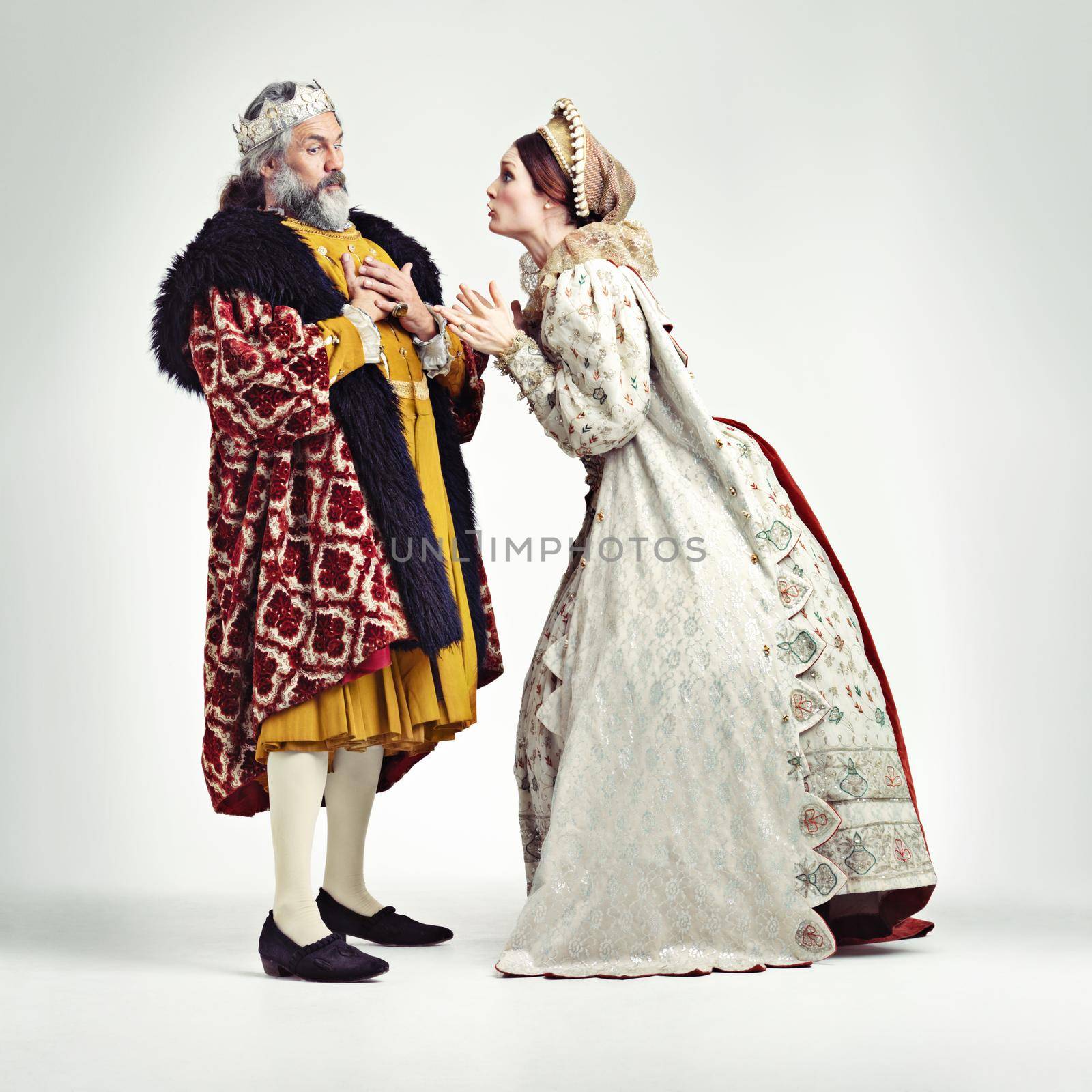 Studio shot of a king and queen arguing