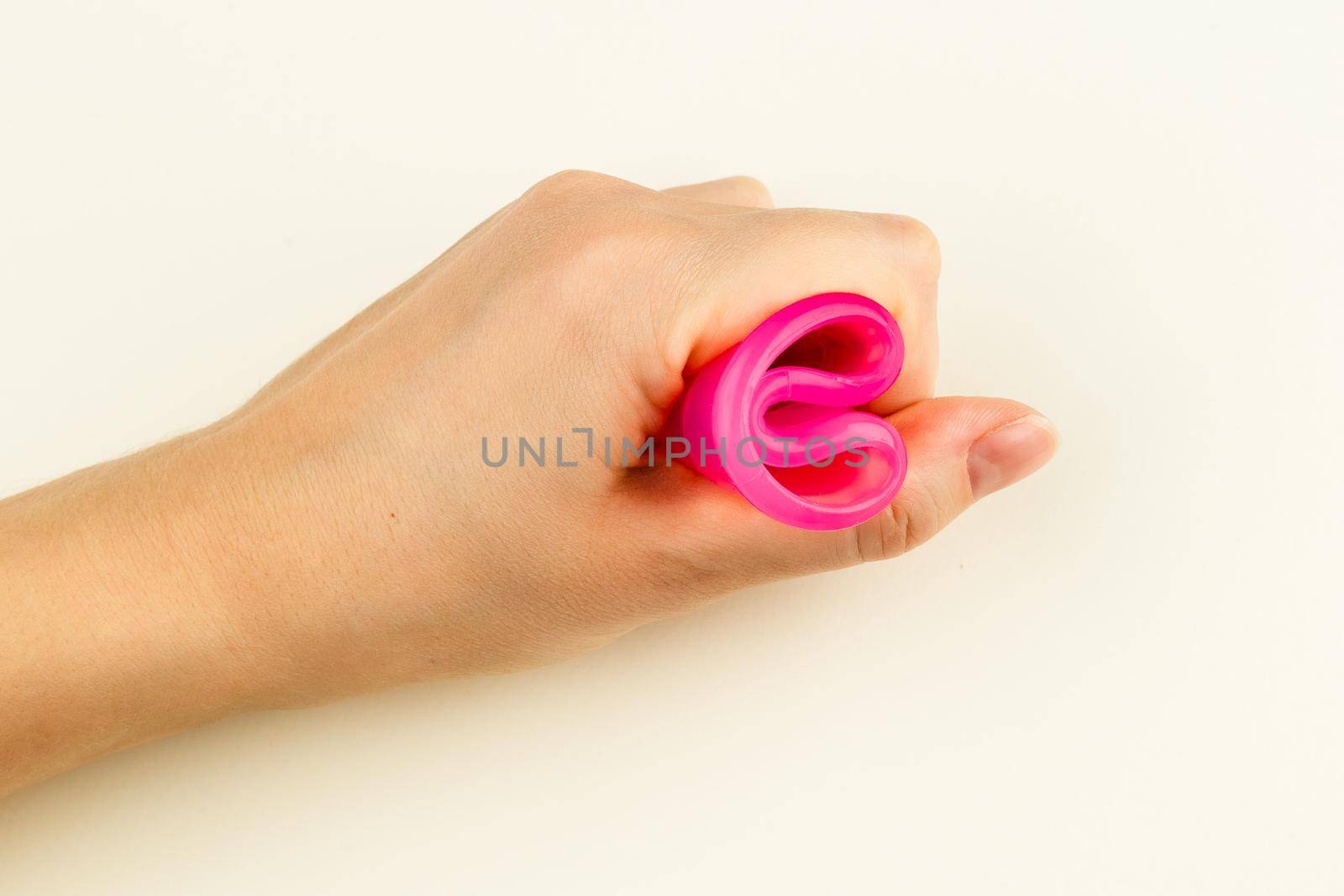 Pink Menstrual Cup folded with a C-Fold Method by Syvanych