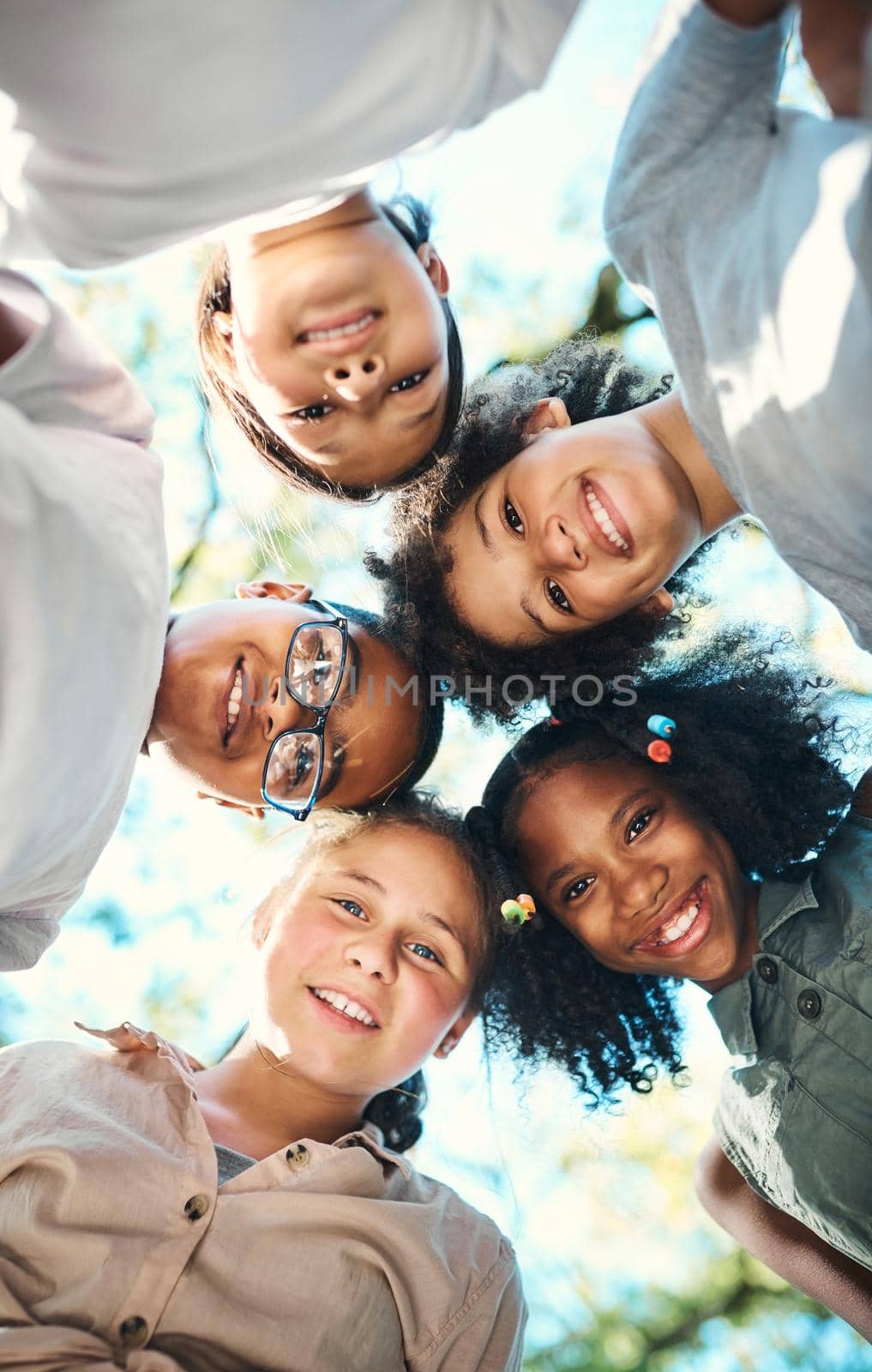 Shot of a group of teenagers standing in a circle in nature at summer camp