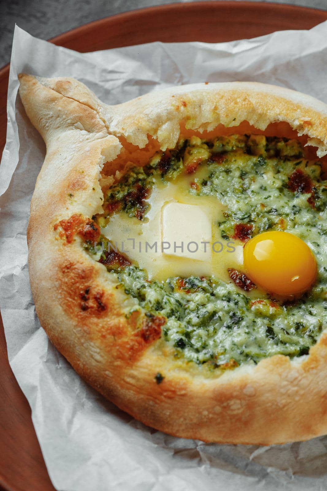 Some khachapuri traditional Georgian homemade cheese and spinach pies on the plate.