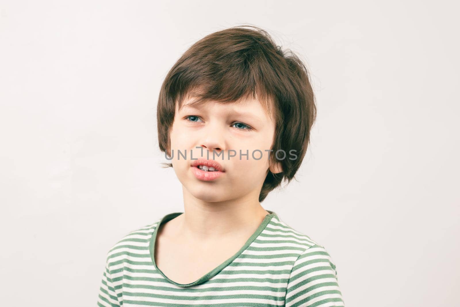 Portrait of Caucasian boy with lazy unhappy bored face