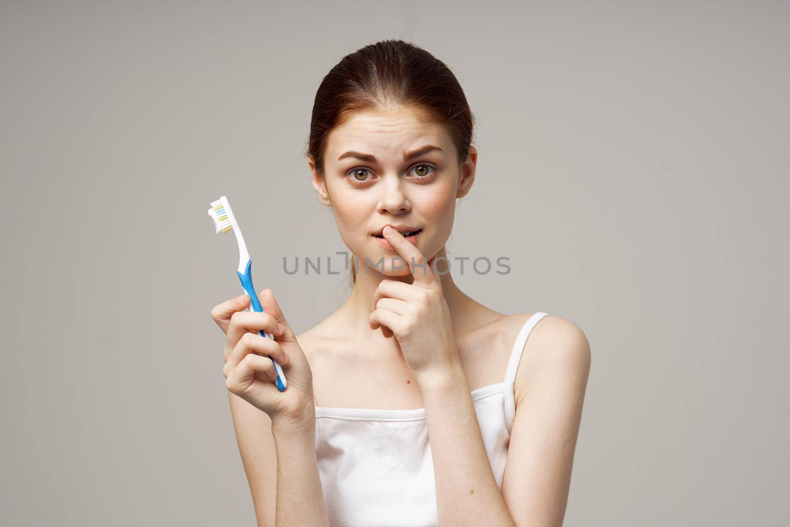cheerful woman toothpaste brushing teeth dental health studio lifestyle. High quality photo