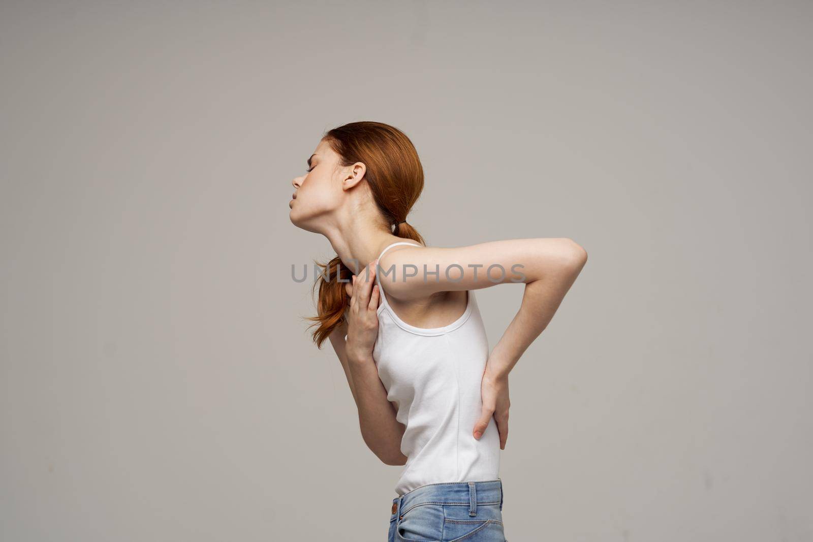 woman back pain health problems osteoporosis isolated background by SHOTPRIME