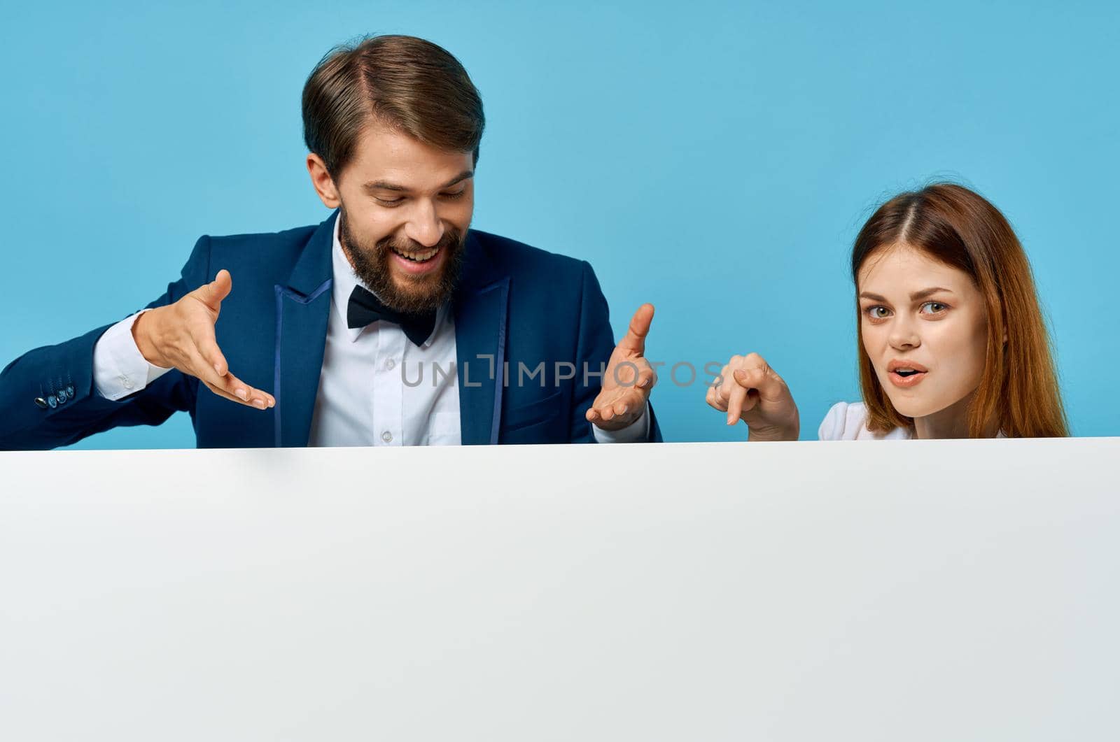 funny man and woman advertising presentation white banner blue background. High quality photo