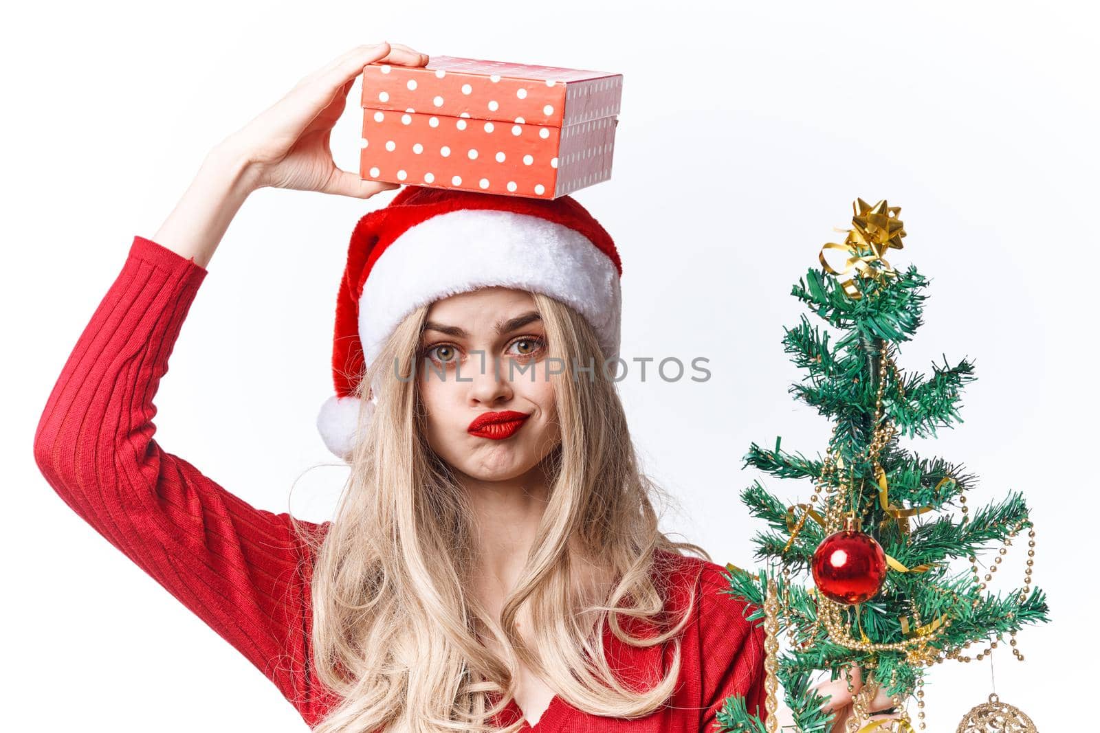 joyful woman christmas gifts decoration light background by SHOTPRIME