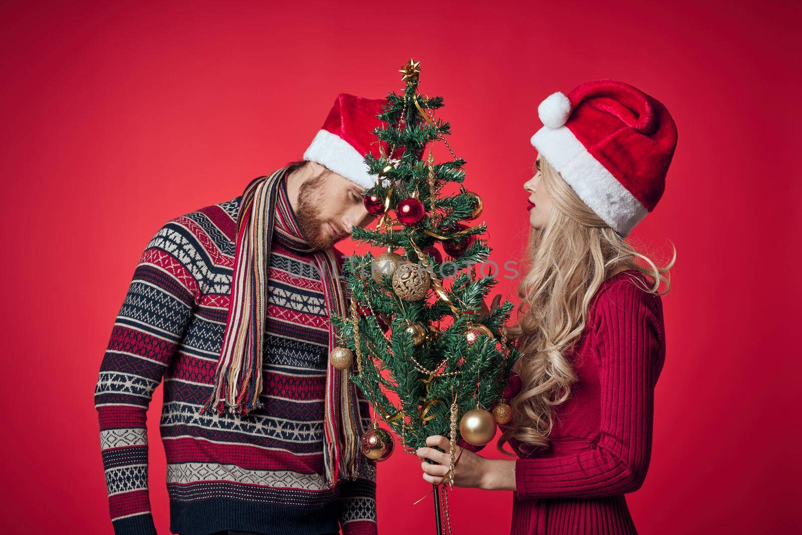 man and woman christmas holiday new year romance red background. High quality photo